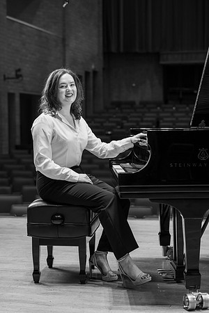 Music major, Kaitlynd Ruesch at the grand piano preparing for here senior recital in the Barrus Concert Hall.