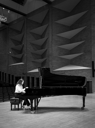 Music major, Kaitlynd Ruesch at the grand piano preparing for here senior recital in the Barrus Concert Hall.