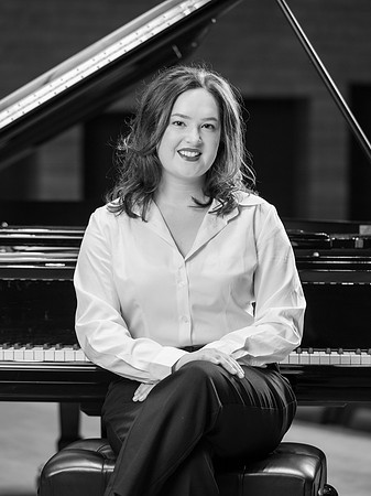 Music major, Kaitlynd Ruesch at the grand piano preparing for here senior recital in the Barrus Concert Hall.