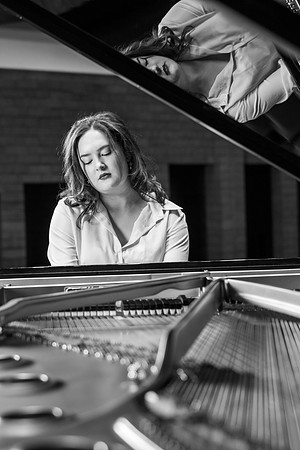 Music major, Kaitlynd Ruesch at the grand piano preparing for here senior recital in the Barrus Concert Hall.