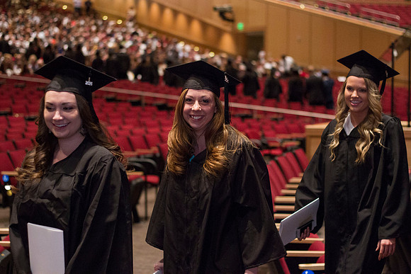 Graduates eagerly leave the I-Center at the end of Commencement during the 2014 Winter Semester Graduation.