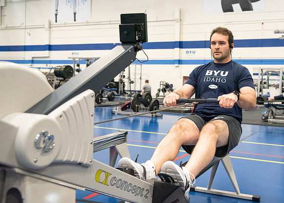 A student using the rowing machine at the Hart Fitness Center.