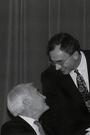 Elder Joe J. Christensen talking to faculty member.