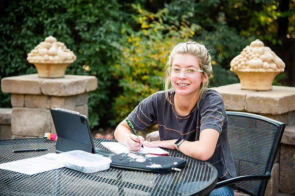 Student studying in the Ricks gardens.