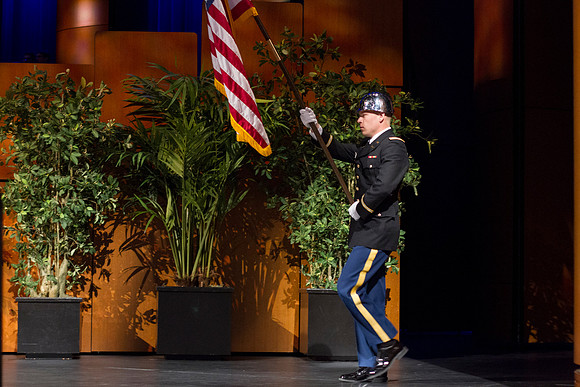 Newly commissioned 2LT Zvirzdin brings in the flag during the Commencement Ceremony in the i-Center during the 2014 Winter Semester Graduation.