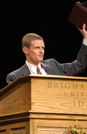Pres. David A Bednar displays his scriptures to show he is ready to learn.