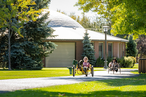 Students in Keith Barney's Adaptive Recreation class get the opportunity to ride hand pedal tricycles at Porter Park.