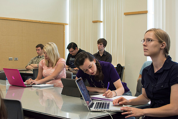Design students go over their projects in Identity Design with instructor Scott Franson. These projects cover the use of logos and images in businesses.