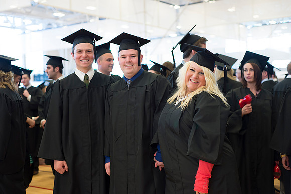 Graduates wait inside the gym area preparing to enter Commencement ceremony.