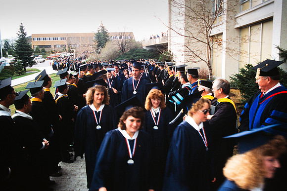 Graduates march into the Hart building during the processional.