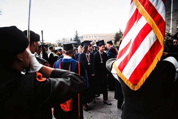 Graduates march into the Hart building during the processional.