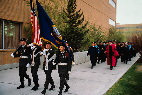 Graduates march into the Hart building during the processional. ROTC Color Guard