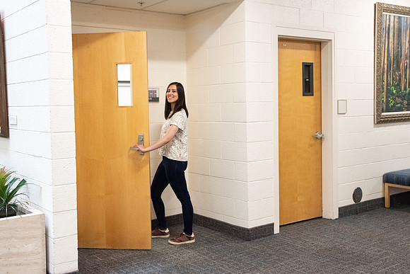 Examples of students staying safe and healthy during the COVID-19 pandemic by social distancing, following pathway arrows, and wearing face masks.