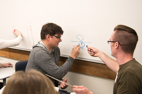 Group problem-solving in Brother Kelson's biology class.