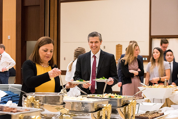 Elder Joaquin E. Costa and Sister Renee Costa have a devotional luncheon with the students before the devotional on Tuesday.