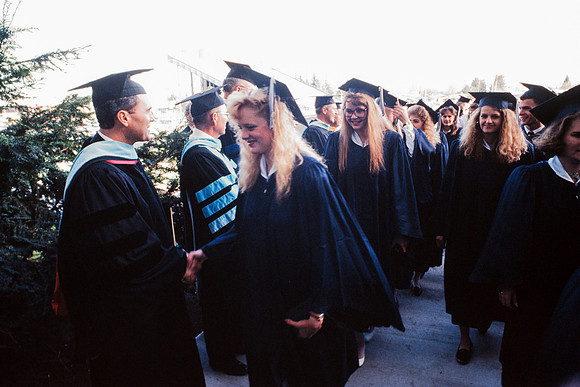 President Bennion shaking graduates' hands