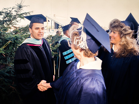 President Bennion shaking graduates' hands