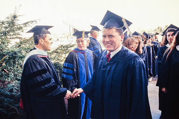 President Bennion shaking graduates' hands