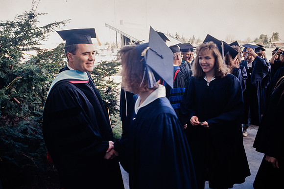 President Bennion shaking graduates' hands