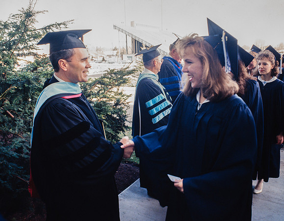 President Bennion shaking graduates' hands
