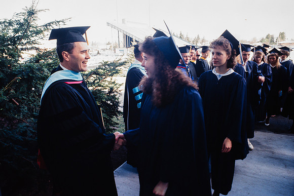 President Bennion shaking graduates' hands