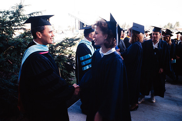 President Bennion shaking graduates' hands