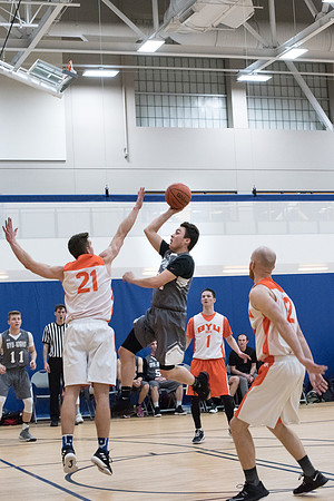 Men's competitive basketball teams play in their final games before tournament.