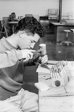 Woodworking student works diligently on the details of his piece. Jan 1993.