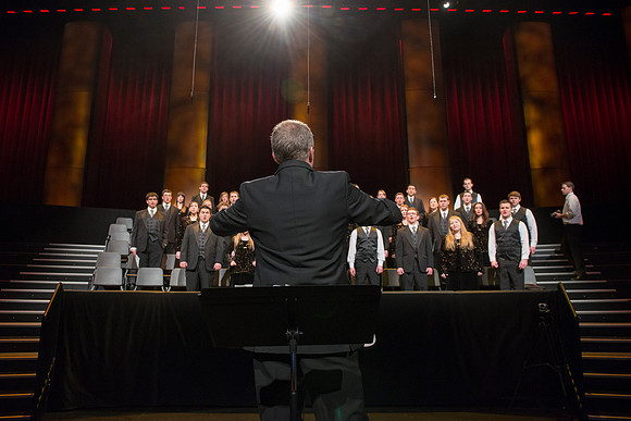 Randall Kempton rehearses with the Collegiate Singers in the BYU-Idaho Center before devotional.