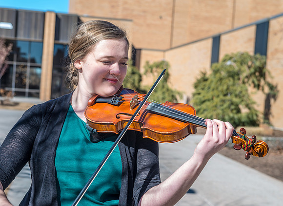 Fiddler, practicing outside the Snow Building on a beautiful sunny day.