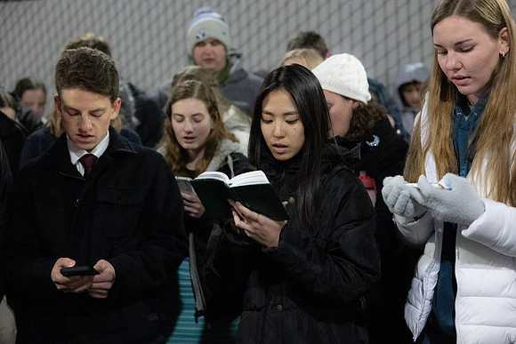 BYU-Idaho students participate in singing hymns under the stadium.