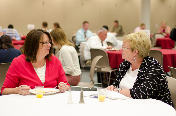 Online instructors gather for breakfast and instruction.