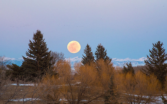 The third Supermoon of the year rising over the mountain tops. March 2019