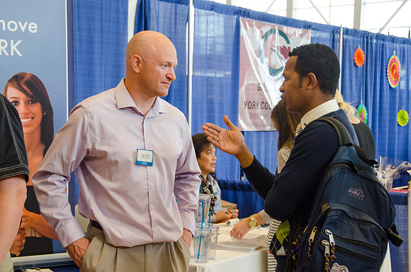 BYU-Idaho students speak to representatives from colleges or companies from their field of study at a career fair held in the I-Center gym