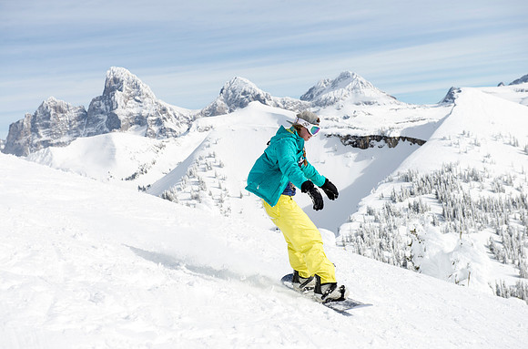 BYU-Idaho students taking a snowboarding class, snowboard with the Tetons in the background.
