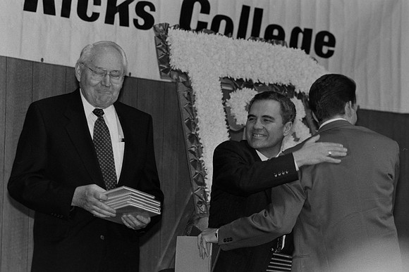 Elder Perry and President Bennion handing out awards