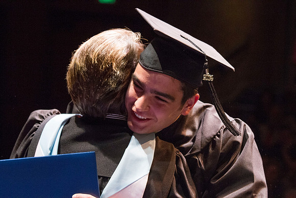 Dean's of the College of Performing and Visual Arts award diplomas to graduates during convocation held in the Snow Building. Photo by Tyler Rickenbach