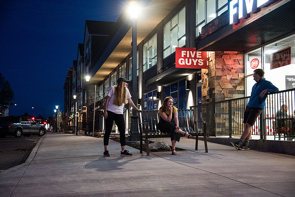 People enjoy Hemming Village in downtown Rexburg on a warm spring night.