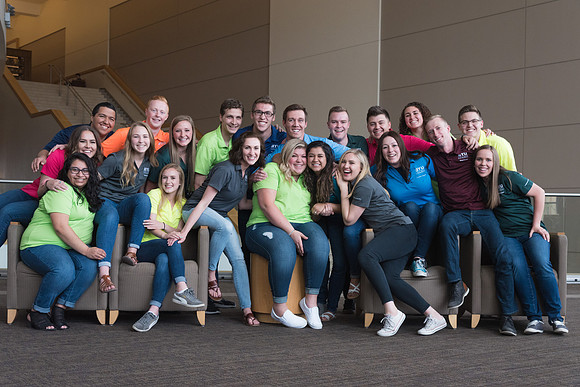 Group photos in the BYU-Idaho Center for the various student support teams.