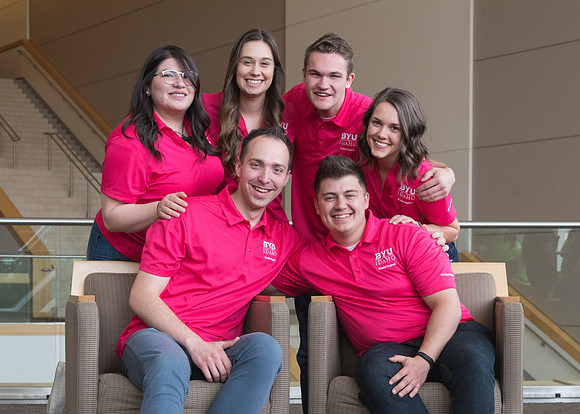 Group photos in the BYU-Idaho Center for the various student support teams.