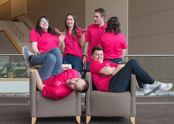 Group photos in the BYU-Idaho Center for the various student support teams.