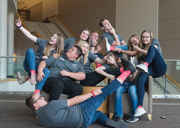 Group photos in the BYU-Idaho Center for the various student support teams.