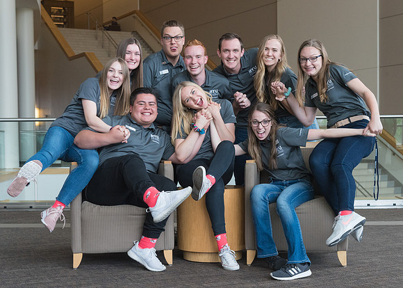 Group photos in the BYU-Idaho Center for the various student support teams.