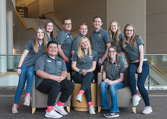 Group photos in the BYU-Idaho Center for the various student support teams.
