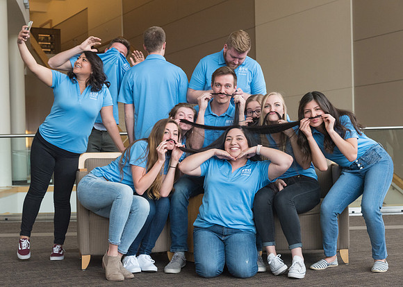 Group photos in the BYU-Idaho Center for the various student support teams.