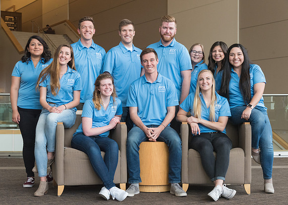 Group photos in the BYU-Idaho Center for the various student support teams.