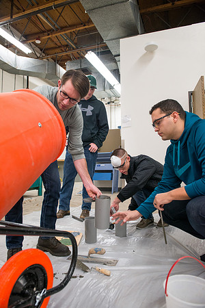 Civil engineering students work with different mixtures of cement to make a light, yet durable, cement that will be the building material for a canoe.