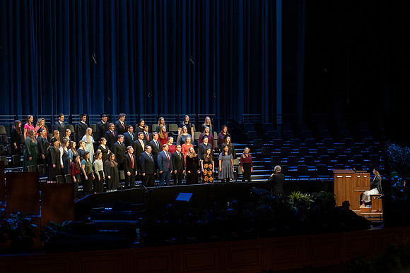 BYU-Idaho graduates gather in the I-Center to hear from Elder Carlos A. Godoy of the Seventy as he speaks at commencement.