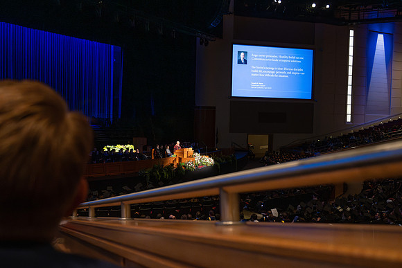 BYU-Idaho graduates gather in the I-Center to hear from Elder Carlos A. Godoy of the Seventy as he speaks at commencement.