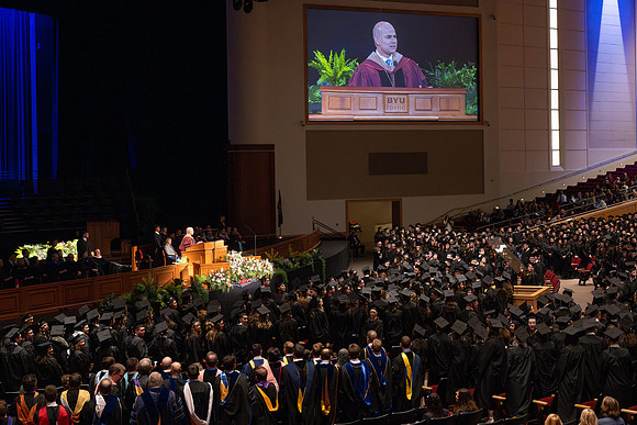 BYU-Idaho graduates gather in the I-Center to hear from Elder Carlos A. Godoy of the Seventy as he speaks at commencement.